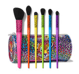 Blend bright 7- piece face & eye brush set, all of the brushes have a tiger pattern on the top; first, the blush brush is pink, then the Highlighter Brush color orange, the Firm Shadow Brush color yellow, Pointed Deluxe Blender Brush color green, Round Blender Brush color blue and the Tapered Mini Blending Brush color purple, at the back the brush bag, showing the character forest, and on the backward a colorful and holographic tiger pattern.