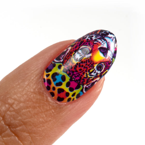 One fingernail with the nail wrap that shows the character Hunter™ and at the back the colors blue, purple, pink, and red in dots on colorful backward.