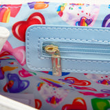 The inside of the bag has a blue zipper, and fabric with hearts some of them have the characters Markie and Celeste, and the other ones are filled with different colors, like, red, blue, pink, orange, and purple.