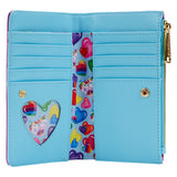 The inside contains 7 slots for holding cards and a clear slot with a heart shape, all in blue, and it has a fabric on the inside with hearts of different colors, some of them with Markie and Celeste.