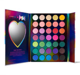 Cosmetic product opened, heart mirror on the left and cosmetic swatches on the right side. Swatch colors variety came from white, skin, pink, green, purple, blue and dark brown