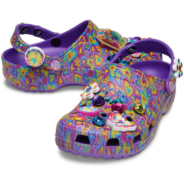 Classic Lisa Franck Crocs each shoe is decked out in signature Lisa Frank designs with colorful hearts on a purple background and includes a whimsical and wonderful collection Jibbitz™ charms like the piece and love sine with the lisa frank colors, a flower, a butterfly, a red, purple and blue diamond and the word groovy in different colors, and a love charm.
